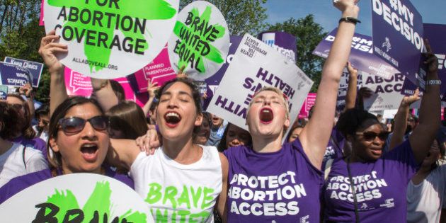 Abortion rights activists, from left, Ravina Daphtary of Philadelphia, Morgan Hopkins of Boston, and Alison Turkos of New York City, rejoice in front of the Supreme Court in Washington, Monday, June 27, 2016, as the justices struck down the strict Texas anti-abortion restriction law known as HB2. Other cases are to follow on guns, and public corruption. (AP Photo/J. Scott Applewhite)