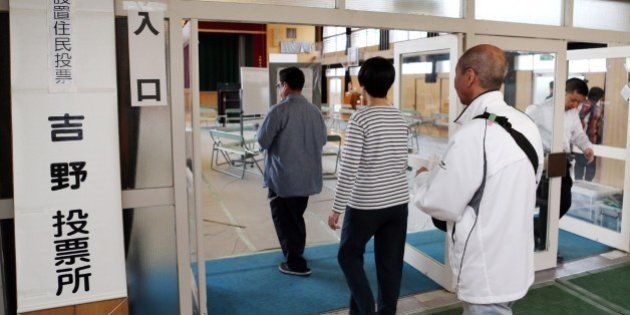 Residents enter a polling station in Osaka on May 17, 2015 to voite on a referendum to reform the city administration into a metropolitan government. The people of Osaka started voting on a plan to streamline Japan's second city in the mould of global metropolises like London, New York and Tokyo, as the one-time commercial capital seeks to recapture its glory days. JAPAN OUT -- AFP PHOTO / JIJI PRESS (Photo credit should read JIJI PRESS/AFP/Getty Images)