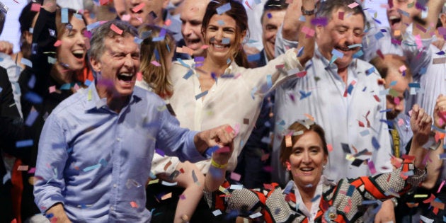 Opposition presidential candidate Mauricio Macri, left, and running mate Gabriela Michetti celebrate after winning a runoff presidential election in Buenos Aires, Argentina, Sunday, Nov. 22, 2015. Macri won Argentina's historic runoff election against ruling party candidate Daniel Scioli, putting an end to the era of President Cristina Fernandez, who along with her late husband dominated Argentine politics for 12 years. (AP Photo/Ricardo Mazalan)