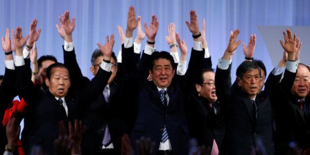 Japan's Prime Minister Shinzo Abe (C) shouts