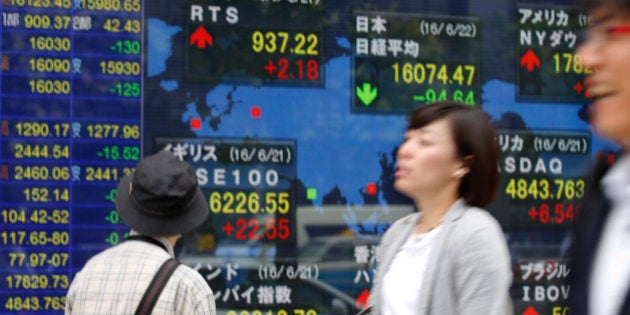 A man looks at an electronic stock indicator of a securities firm in Tokyo, Wednesday, June 22, 2016. Asian shares were mostly higher Wednesday, with investors focused on Thursday's vote on Britain's possible withdrawal from the European Union and after relief over U.S. Federal Reserve Chair Janet Yellen's statement that the Fed would remain cautious in raising interest rates. (AP Photo/Shizuo Kambayashi)