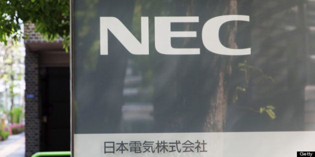 NEC Corp.'s logo is displayed in front of the company's headquarters in Tokyo, Japan, on Friday, April 26, 2013. NEC, a Japanese maker of wireless base stations, will get 130 billion yen ($1.3 billion) of financial support from lenders and sell its stake in a mobile phone sales unit to Marubeni Corp. Photographer: Noriyuki Aida/Bloomberg via Getty Images
