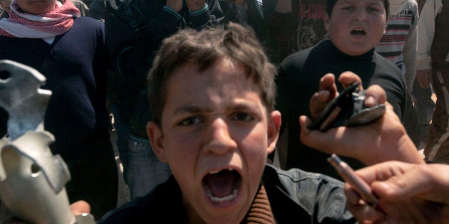 Syrians carry the coffin of 13-year-old Ahmad bin Muhsin Qarush during his funeral on March 24, 2012 who was reportedly killed two days earlier in shelling by regime forces in the northwestern city of Sermin. Syrian forces bombed towns and clashed with rebels in several regions as activists said thousands staged anti-regime protests and the European Union slapped sanctions on the country's First Lady. AFP PHOTO/RICARDO GARCIA VILANOVA (Photo credit should read Ricardo Garcia Vilanova/AFP/Getty Images)