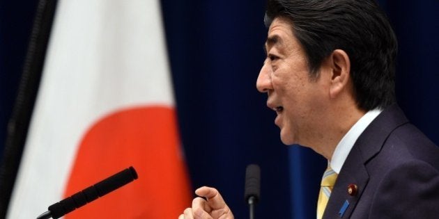 Japan's Prime Minister Shinzo Abe delivers a speech during a press conference following a cabinet meeting which approved a set of bills bolstering the role and scope of the military, at his official residence in Tokyo on May 14, 2015. The bills are a pet project of nationalist Prime Minister Abe, who says Japan can no longer shy away from its responsibility to help safeguard regional stability, and must step out from under the shade of the security umbrella provided by the United States. AFP PHOTO / TOSHIFUMI KITAMURA (Photo credit should read TOSHIFUMI KITAMURA/AFP/Getty Images)