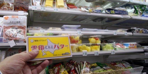 A customer picks up a block of butter at a food store in Tokyo on November 10, 2014. Japanese shoppers are up in arms over a serious butter shortage that has forced Tokyo to resort to emergency imports, as some grocers limit sales to one block per customer. AFP PHOTO / Yoshikazu TSUNO (Photo credit should read YOSHIKAZU TSUNO/AFP/Getty Images)