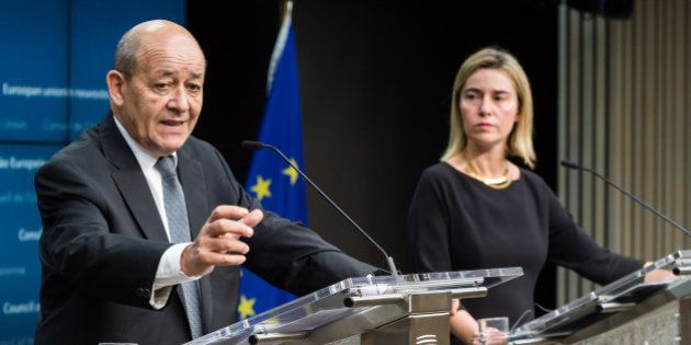 European Union High Representative for Foreign Affairs and Security Policy Federica Mogherini, right, and France's Defense Minister Jean-Yves Le Drian address the media during an EU foreign and defense ministers meeting at the EU Council building in Brussels on Tuesday, Nov. 17, 2015. France has demanded that its European partners provide support for its operations against the Islamic State group in Syria and Iraq and other security missions in the wake of the Paris attacks. (AP Photo/Geert Vanden Wijngaert)