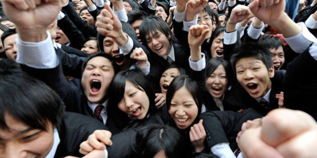 College students raise their arms and shout at the start of a job hunting ceremony in Tokyo on February 8, 2011. Some 1,500 students, who will graduate from schools in March 2012, attended the annual ceremony to encourage themselves to look for jobs. AFP PHOTO / Toru YAMANAKA (Photo credit should read TORU YAMANAKA/AFP/Getty Images)