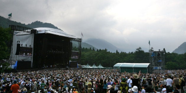 YUZAWA, JAPAN - JULY 26: People enjoy a concert during the Fuji Rock Festival at Naeba Ski Resort on July 26, 2008 in Yuzawa, Niigata, Japan. (Photo by Kiyoshi Ota/Getty Images)