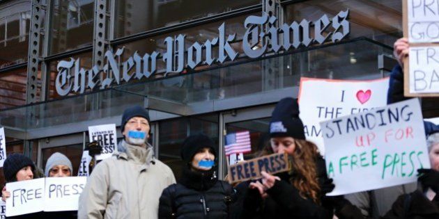 People take part in a protest outside the New York Times on February 26, 2017 in New York. The White House denied access Frebuary 24. 2017 to an off-camera briefing to several major US media outlets, including CNN and The New York Times. Smaller outlets that have provided favorable coverage however were allowed to attend the briefing by spokesman Sean Spicer. The WHCA said it was 'protesting strongly' against the decision to selectively deny media access. The New York Times said the decision was 'an unmistakable insult to democratic ideals,' CNN called it 'an unacceptable development,' and The Los Angeles Times warned the incident had 'ratcheted up the White House's war on the free press' to a new level. / AFP / KENA BETANCUR (Photo credit should read KENA BETANCUR/AFP/Getty Images)