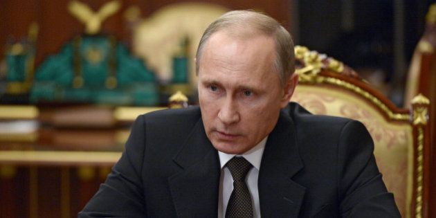 Russian President Vladimir Putin heads a meeting on Russian plane crash in Egypt in Moscow's Kremlin, Russia, early Tuesday, Nov. 17, 2015. The head of Russia's FSB security service says the crash of the passenger plane in Egypt was the result of a 'terrorist' act. Alexander Bortnikov told Putin on Tuesday that a homemade explosive device blew up on the plane. All 224 people on board the plane, most of them Russian tourists, were killed in the Oct. 31 crash. (Alexei Nikolsky/SPUTNIK, Kremlin Pool Photo via AP)
