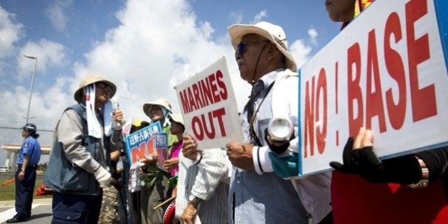 OKINAWA, JAPAN - JUNE 17: People stage a rally against past incident of rape of a Japanese woman and drunk driving in Okinawa over American military presence in Japan in front of the US base in Camp Schwab, on June 17, 2016 in Nago, Okinawa, Japan. (Photo by Richard Atrero de Guzman/Anadolu Agency/Getty Images)