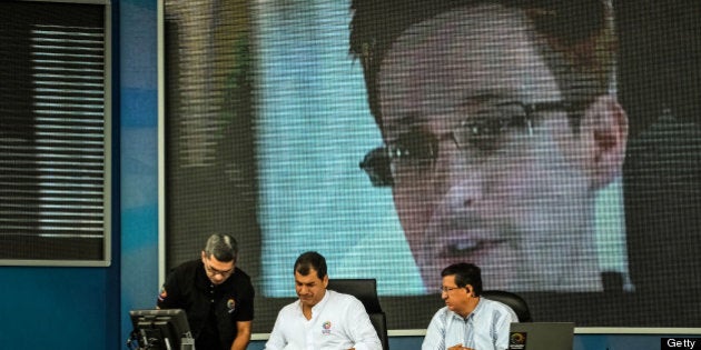 Rafael Correa, president of Ecuador, center, pauses during his weekly speech to the nation broadcast on public radio in Manta, Ecuador, on Saturday, June 29, 2013. Ecuador, the South American nation considering an asylum request from fugitive U.S. intelligence leaker Edward Snowden, renounced its U.S. trade benefits, saying they were being used as 'blackmail.' Photographer: Meridith Kohut/Bloomberg via Getty Images