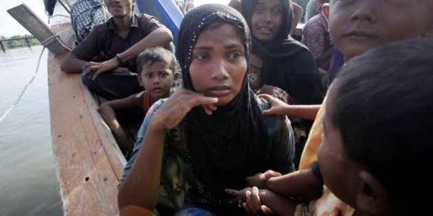 Rescued migrants weep upon arrival Simpang Tiga, Aceh province, Indonesia, Wednesday, May 20, 2015. Hundreds of migrants stranded at sea for months were rescued and taken to Indonesia, officials said Wednesday, the latest in a stream of Rohingya and Bangladeshi migrants to reach shore in a growing crisis confronting Southeast Asia. (AP Photo/Binsar Bakkara)