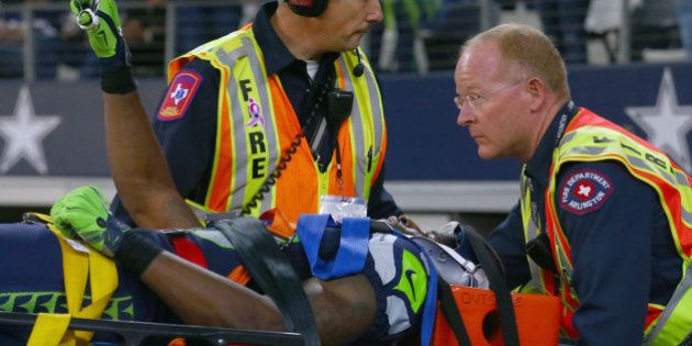 ARLINGTON, TX - NOVEMBER 01: Ricardo Lockette #83 of the Seattle Seahawks waves to fans while being carted off the field in the second quarter at AT&T Stadium on November 1, 2015 in Arlington, Texas. (Photo by Tom Pennington/Getty Images)