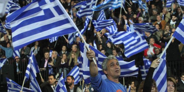 ATHENS, GREECE - JANUARY 23: Supporters of the New Democracy party wave Greek national flags during Greek Prime Minister Antonis Samaras' final pre-election rally in Athens, Greece, on January 23, 2015. (Photo by Ayhan Mehmet/Anadolu Agency/Getty Images)
