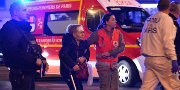 PARIS, FRANCE - NOVEMBER 14: Medics carry the woundeds to the ambulances near Le Petit Cambodge restaurant in the 11th district after a drive-by shooting killing 11 people, November 14, 2015, Paris, France. At least 142 people were killed deadly shootings and explosions took place in several neighbourhoods of Paris. (Photo by Mustafa Yalcin/Anadolu Agency/Getty Images)