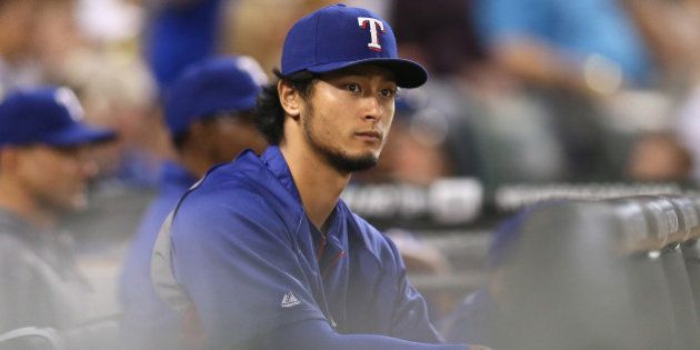 CHICAGO, IL - AUGUST 05: Yu Darvish #11 of the Texas Rangers watches a game against the Chicago White Sox from the dugout at U.S. Cellular Field on August 5, 2014 in Chicago, Illinois. (Photo by Jonathan Daniel/Getty Images)