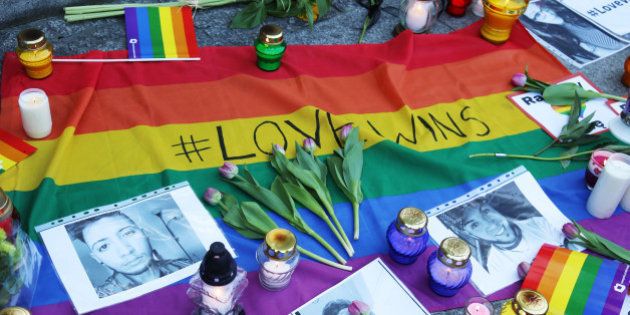 EMBASSY OF THE UNITED STATES OF AMERICA, WARSAW, POLAND - 2016/06/13: Flowers, candles, and flags are seen in front of the Embassy of the United States of America in Warsaw, Poland as a tribute to the victims of the horrific mass shooting that killed 50 people and left over 50 more injured in Orlando, Florida. The shooting took place in a LGBT friendly nightclub called Pulse in Orlando over the weekend. One day before, in Warsaw, Poland, and across many other European and American cities, thousands of people took part of Gay Pride parades. The shooter who was killed in the shooting has been identified as Omar Mateen, a 29-year-old man born in New York with Afghan origins. This latest shooting is the worst mass shooting in the history of the United States. (Photo by Anna Ferensowicz/Pacific Press/LightRocket via Getty Images)