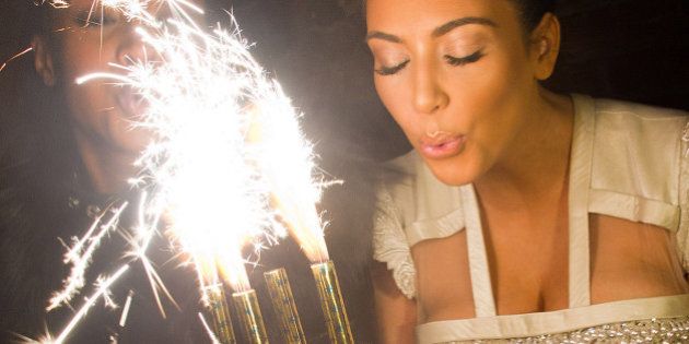 Kim Kardashian blows out the candles on a cake in celebration of her 30th Birthday at the 10th Anniversary of TAO restaurant in New York, early Sunday, Oct. 17, 2010. (AP Photo/Charles Sykes)