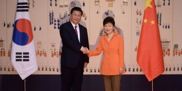 China's President Xi Jinping (L) shakes hands with his South Korean counterpart Park Geun-Hye (R) prior to a summit meeting at the Blue House in Seoul on July 3, 2014. China's president arrived in Seoul for a state visit seen as a snub to Beijing's traditional ally North Korea, whose nuclear weapons ambitions will dominate talks with South Korean leader Park Geun-Hye. AFP PHOTO / Ed Jones / POOL (Photo credit should read ED JONES/AFP/Getty Images)