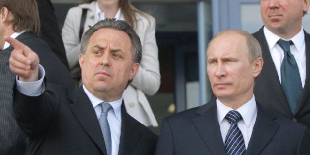 FILE - In this May 16, 2011 file photo then Russian Prime Minister Vladimir Putin, right, is flanked by Sports Minister Vitaly Mutko, left, as they visit a sports complex that is under construction for the 2014 Winter Olympic Games, in Krasnodar, southern Russia. WADA's independent commission said Monday, Nov. 9, 2015 Russia's athletics federation should be suspended and its track and field athletes banned from competition until the country cleans up its act on doping. (AP Photo/RIA Novosti, Alexei Druzhinin, Pool, file)