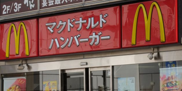 A man enters a McDonald's restaurant, operated by McDonald's Holdings Co. Japan Ltd., in Tokyo, Japan, on Wednesday, July 23, 2014. Japan suspended food imports from Shanghai Husi Food Co., a unit of Aurora, Illinois-based OSI Group, accused of selling products past their expiration dates as FamilyMart Co. joined McDonalds Corp. in pulling affected items from its Japanese outlets. Photographer: Yuriko Nakao/Bloomberg via Getty Images