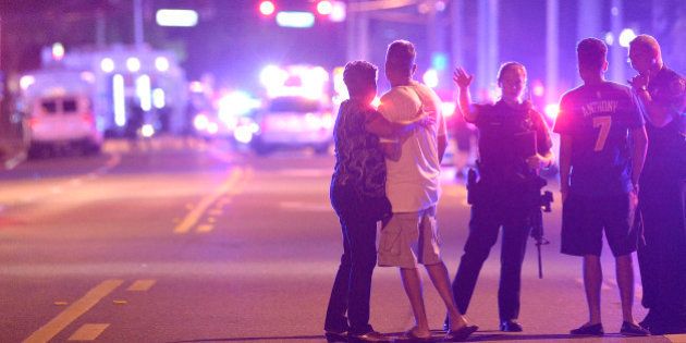 Orlando Police officers direct family members away from a multiple shooting at a nightclub in Orlando, Fla., Sunday, June 12, 2016. A gunman opened fire at a nightclub in central Florida, and multiple people have been wounded, police said Sunday. (AP Photo/Phelan M. Ebenhack)