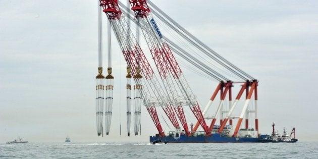 A giant offshore crane is seen near the site of a capsized ferry at sea off Jindo on April 18, 2014. South Korean divers renewed efforts on April 18 to access a capsized ferry in which hundreds of schoolchildren are feared trapped, as the grief and frustration of anguished parents gave way to anger and recrimination.AFP PHOTO / JUNG YEON-JE (Photo credit should read JUNG YEON-JE/AFP/Getty Images)