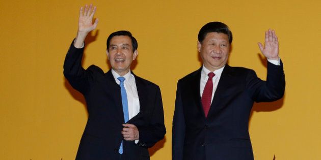 Chinese President Xi Jinping, right, and Taiwanese President Ma Ying-jeou, left, wave to the media at the Shangri-la Hotel on Saturday, Nov. 7, 2015, in Singapore. The two leaders shook hands at the start of a historic meeting, marking the first top level contact between the formerly bitter Cold War does since they split amid civil war 66 years ago. (AP Photo/Wong Maye-E)