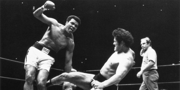 Japanese pro wrestler Antonio Inoki kicks the back of Muhammad Ali's leg in an attempt to trip him down on the mat during their boxing-wrestling bout at the Budokan Hall in Tokyo, June 26, 1976. Inoki challenged the World Heavyweight boxing champion in a 15-round fight billed as
