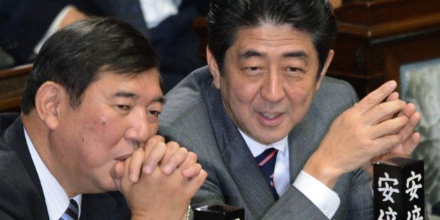 Shinzo Abe (R) chats with Secretary General of the Liberal Democratic Party (LDP) Shigeru Ishiba (L) before voting to elect a new prime minister at the lower house of parliament in Tokyo on December 26, 2012. The powerful lower house named the 58-year-old Abe as the country's new leader following a resounding national election victory for Abe's LDP earlier this month over the booted Democratic Party of Japan (DPJ). AFP PHOTO/Toru YAMANAKA (Photo credit should read TORU YAMANAKA/AFP/Getty Images)