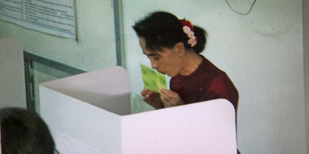 YANGON, MYANMAR - 2015/11/08: NLD leader Aung San Suu Kyi kisses her ballot, at a polling station, during the first general elections in 25 years in Yangon, Myanmar. The NLD is expected to have a landslide victory. (Photo by Stephen J. Boitano/LightRocket via Getty Images)