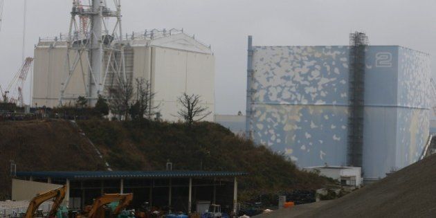 A building covering the Unit 1 reactor (L) is removed by a crane at the Fukushima Dai-ichi nuclear power plant in Okuma, Fukushima Prefecture, northeastern Japan on November 12, 2014. The final obstacle to restarting two nuclear reactors in Japan was removed on November 7 when local politicians granted approval for a plant to go back online, more than three years after the Fukushima disaster. AFP PHOTO / POOL / Shizuo Kambayashi (Photo credit should read SHIZUO KAMBAYASHI/AFP/Getty Images)