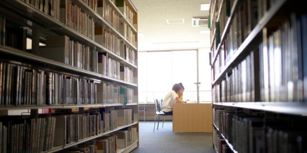 Two female student reading in library