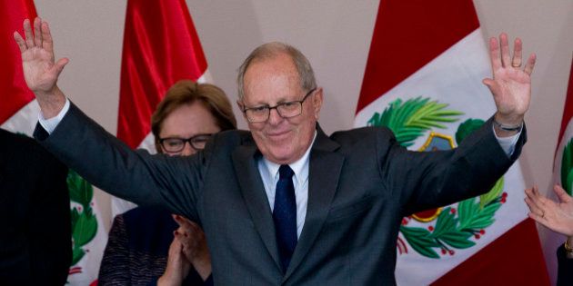 Presidential candidate Pedro Pablo Kuczynski acknowledges the crowd at the end of a news conference in Lima, Peru, Thursday, June 9, 2016. Kuczynski won the majority of votes in the country's closest presidential contest in five decades, Peruvian electoral authorities said Thursday. His rival Keiko Fujimori has yet to concede however. (AP Photo/Silvia Izquierdo)