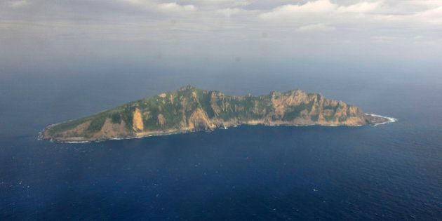 FILE - In this Dec. 13, 2012 file photo released by China's Xinhua News Agency, one of the small islands in the East China Sea known as Senkaku in Japanese and Diaoyu in Chinese is seen from a Chinese marine surveillance plane. China plans eventually to land a survey team on the uninhabited islands at the heart of an increasingly dangerous territorial dispute with Japan, a Chinese official said Tuesday, March 12, 2013, in the latest verbal salvo intended to bolster Beijing's territorial claims. (AP Photo/Xinhua, File) NO SALES