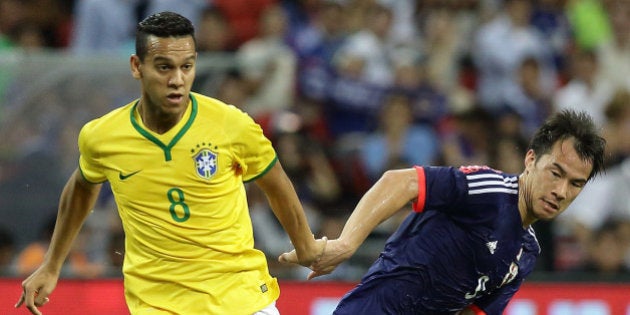 SINGAPORE - OCTOBER 14: Josef Souza of Brazil (L) and Shinji Okazaki of Japan challenge for the ball during the international friendly match between Japan and Brazil at the National Stadium on October 14, 2014 in Singapore. (Photo by Suhaimi Abdullah/Getty Images)