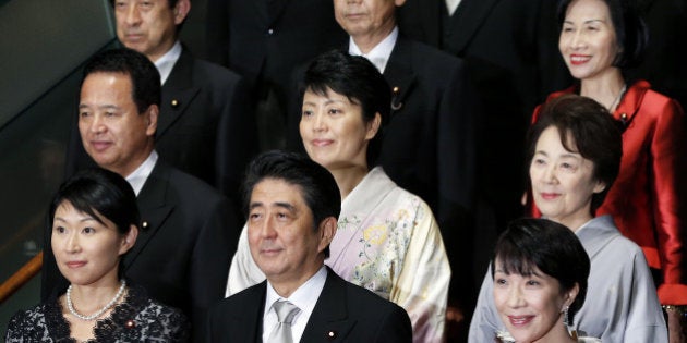 Shinzo Abe, Japan's prime minister, front row center, poses for a group photograph with members of his new cabinet including Yuko Obuchi, Japan's newly appointed economy, trade and industry minister, front row left, and Sanae Takaichi, Japan's newly appointed internal affairs and communications minister, front row right, Haruko Arimura, Japan's newly appointed minister in charge of government revitalization and woman promotion, second row center, Eriko Yamatani, Japan's newly appointed chairwoman of the National Public Safety Commission and minister in charge of abduction issue, second row right, and Midori Matsushima, Japan's newly appointed justice minister, third row right, at the prime minister's official residence in Tokyo, Japan, on Wednesday, Sept. 3, 2014. Abe placed an advocate of pro-market reforms in charge of the government pension fund and named a rising female politician as industry minister as he seeks to restore momentum to his 'Abenomics' policies with a cabinet reshuffle today. Photographer: Kiyoshi Ota/Bloomberg via Getty Images