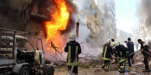 ALEPPO, SYRIA - JUNE 8: Firefighters try to extinguish fire after a helicopter belonging to the Syrian army carried out barrel bomb attacks on Beyan hospital and a bazaar in Aleppo, Syria on June 8, 2016. (Photo by Ibrahim Ebu Leys/Anadolu Agency/Getty Images)