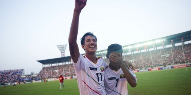 Than Paing of Myanmar (C) celebrates after winning the AFC U-19 Championship quarter-final football match between Myanmar and the United Arab Emirates at Thuwanna stadium in Yangon on October 17, 2014. Myanmar won the match 1-0, securing a place in the U20 world cup. AFP PHOTO / Ye Aung THU (Photo credit should read Ye Aung Thu/AFP/Getty Images)