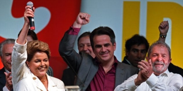 Re-elected Brazilian President Dilma Rousseff celebrates following her win, in Brasilia on October 26, 2014. Leftist incumbent Dilma Rousseff was re-elected president of Brazil, the country's Supreme Electoral Tribunal said, after a down-to-the-wire race against center-right challenger Aecio Neves. Rousseff, who had 51.45 percent of the vote with 98 percent of ballots counted, was declared the run-off winner. AFP PHOTO / EVARISTO SA (Photo credit should read EVARISTO SA/AFP/Getty Images)