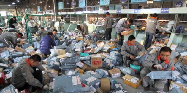 NANTONG, CHINA - NOVEMBER 12: (CHINA OUT) Workers distribute packs at an express company on November 12, 2012 in Nantong, China. Tmall.com and Taobao.com, the China's biggest online shopping sites of Chinese e-commerce giant Alibaba Group Holding, had 19.1 billion yuan (3.04 billion U.S. dollars) in total transactions during its 'Singles' Day' shopping promotion on Sunday. And 'Singles' Day', which has become a shopping festival of e-business groups, caused enormous pressure on express service. (Photo by ChinaFotoPress/ChinaFotoPress via Getty Images)