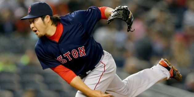 NEW YORK, NY - APRIL 10: Junichi Tazawa #36 of the Boston Red Sox delivers a pitch in the 8th inning against the New York Yankees on April 10, 2015 at Yankee Stadium in the Bronx borough of New York City. (Photo by Elsa/Getty Images)
