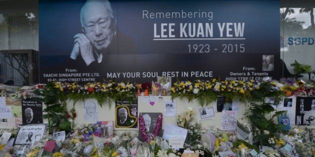 Pictures and flowers are seen in front of a memorial area for Singapore's late former prime minister Lee Kuan Yew outside the parliament building where he lies in state ahead of his funeral in Singapore on March 28, 2015. Singapore's first prime minister Lee Kuan Yew, one of the towering figures of post-colonial Asian politics, died at the age of 91 on March 23. AFP PHOTO / ADEK BERRY (Photo credit should read ADEK BERRY/AFP/Getty Images)