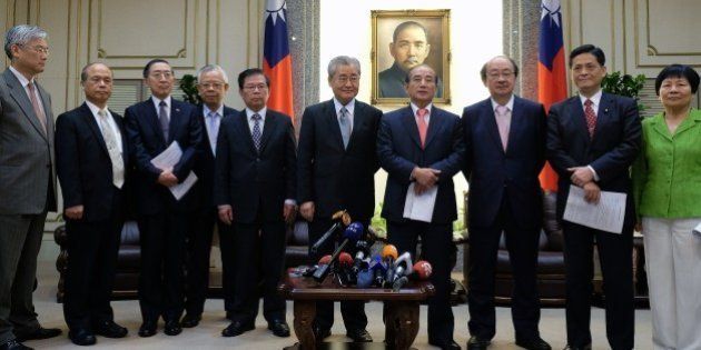Parliament speaker Wang Jin-pyng (4th R) speaks after a meeting with Premier Mao Chi-kuo (5th R), main opposition Democratic Progressive Party (3rd R) party Ker Chien-ming (R) and other party representatives and government officials pose in Taipei on April 1, 2015. Taipei on March 31 issued a letter of intent to join the Beijing-led Asian Infrastructure Bank (AIIB), a Beijing initiative seen as a counterweight to the Washington-backed World Bank and the Japanese-led Asian Development Bank (ADB). AFP PHOTO / Sam Yeh (Photo credit should read SAM YEH/AFP/Getty Images)