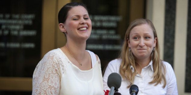 ARLINGTON, VA - OCTOBER 06: Erika Turner (R) and Jennifer Melsop (L) of Centreville, Virginia, rejoice as they becomes the first same sex marriage couple in Arlington County as they speak to members of the media outside Arlington County Courthouse October 6, 2014 in Arlington, Virginia. The U.S. Supreme Court announced that it will not hear the five pending same-sex marriage cases, paving the way for gay and lesbian marriage in 11 more states. (Photo by Alex Wong/Getty Images)