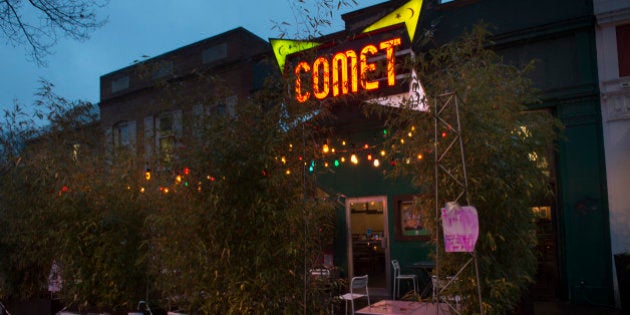 WASHINGTON, DC: DECEMBER 6: Signs of support hang on the building at Comet Ping Pong in Washington, D.C., on Tuesday, December 6, 2016. The business is set to reopen after Edgar Maddison Welch from North Carolina, discharged his assault rifle at the popular Chevy Chase restaurant claiming he was there to investigate a fake news story on the Internet about a child sex ring. (Photo by Nikki Kahn/The Washington Post via Getty Images)