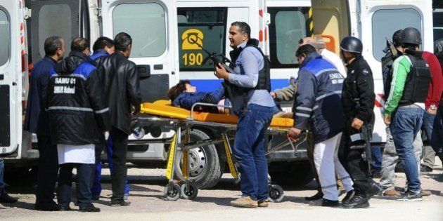 A victim is being evacuated by rescue workers outside the Bardo musum in Tunis, Wednesday, March 18, 2015 in Tunis, Tunisia. Gunmen opened fire at a leading museum in Tunisia's capital, killing at least eight people and wounding six, including foreign tourists, authorities said. A later raid by security forces left two gunmen and one security officer dead but ended the standoff, Tunisian authorities said. (AP Photo/Hassene Dridi)