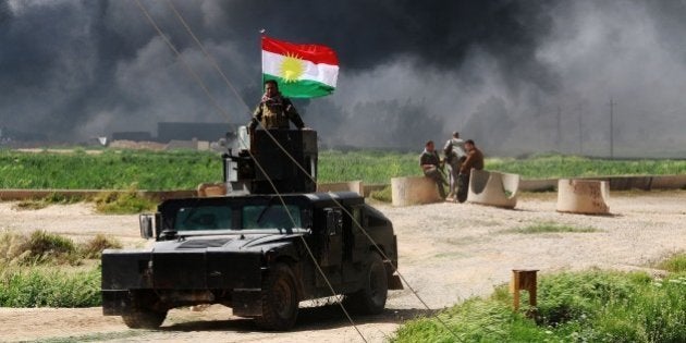 KIRKUK, IRAQ - MARCH 16: Smoke rises when peshmergas stage an operation against Daesh militants in the village of Vahde in Dakuka district on March 16,2015. (Photo by Ali Mukarrem Garip/Anadolu Agency/Getty Images)