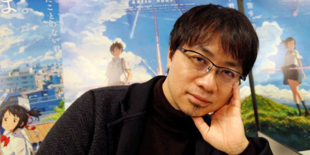 Japanese anime director Makoto Shinkai poses for a photo in front of posters of his animated film 'Your Name' after an interview with Reuters in Tokyo, Japan, November 16, 2016. Picture taken November 16, 2016. REUTERS/Toru Hanai
